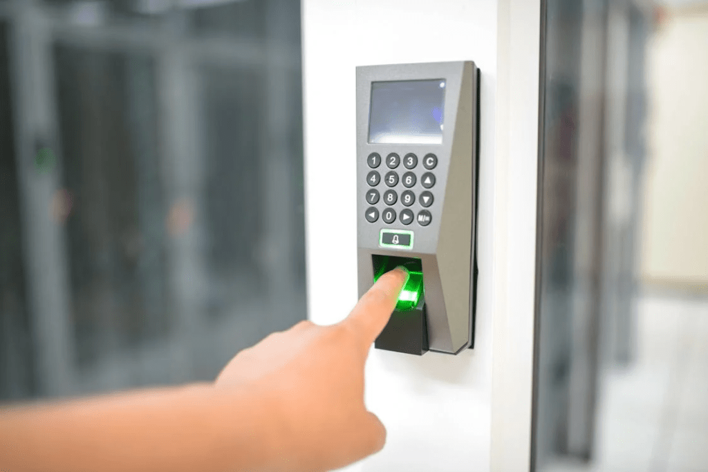 Student using a fingerprint time attendance system integrated with a door access control system in a Dubai educational campus