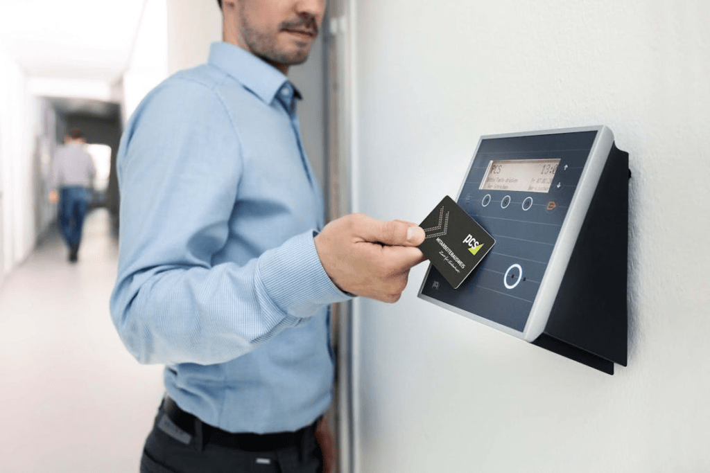 Bank staff member using electronic door access control system at financial institution branch office